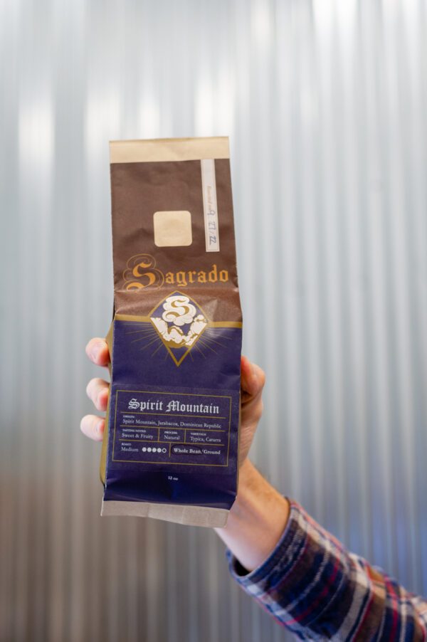 a hand holding a bag of Sagrado Coffee Spirit Mountain